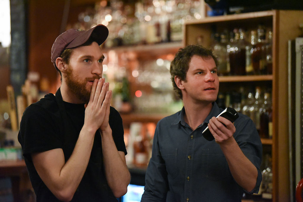 Kyle Youngblood watches as Michael Loesch adjusts the TV settings